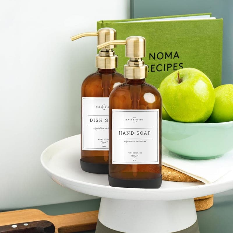 Amber glass soap dispenser set with gold pumps and labels for kitchen sink or bathroom counter styling gallery view 3