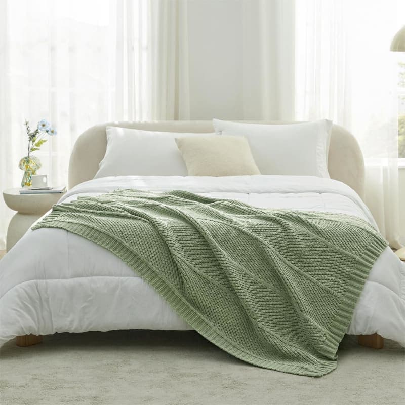 Sage green chunky knit chenille throw blanket styled on a chair for cozy living room decor gallery view 2