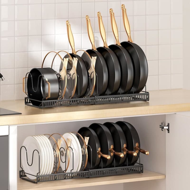 Expandable black cabinet rack holding pans, pot lids, bakeware, and cutting boards in adjustable compartments. gallery view 4