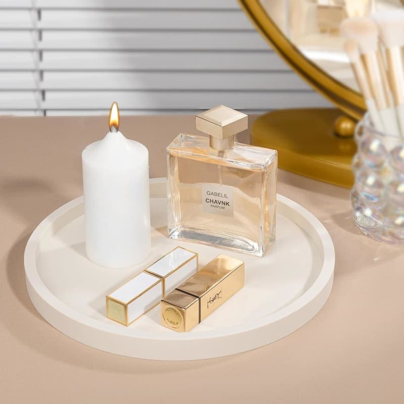 Round beige silicone organizer tray styled with a candle, diffuser, and decorative vase for a bathroom vanity or coffee table. gallery view 4