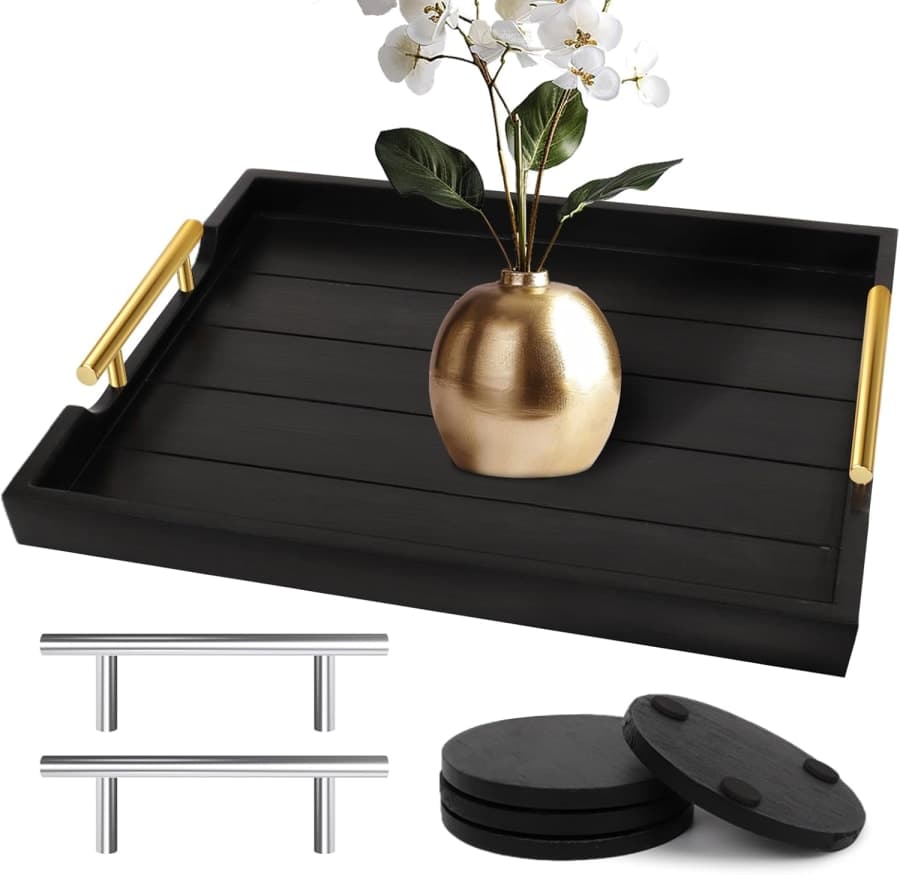 Black wooden coffee table tray with gold handles and coasters for elegant living room styling.