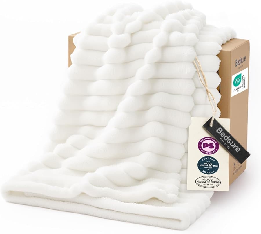 Soft off white fleece throw blanket with plush texture for cozy sofa, bed, and bedroom decor.