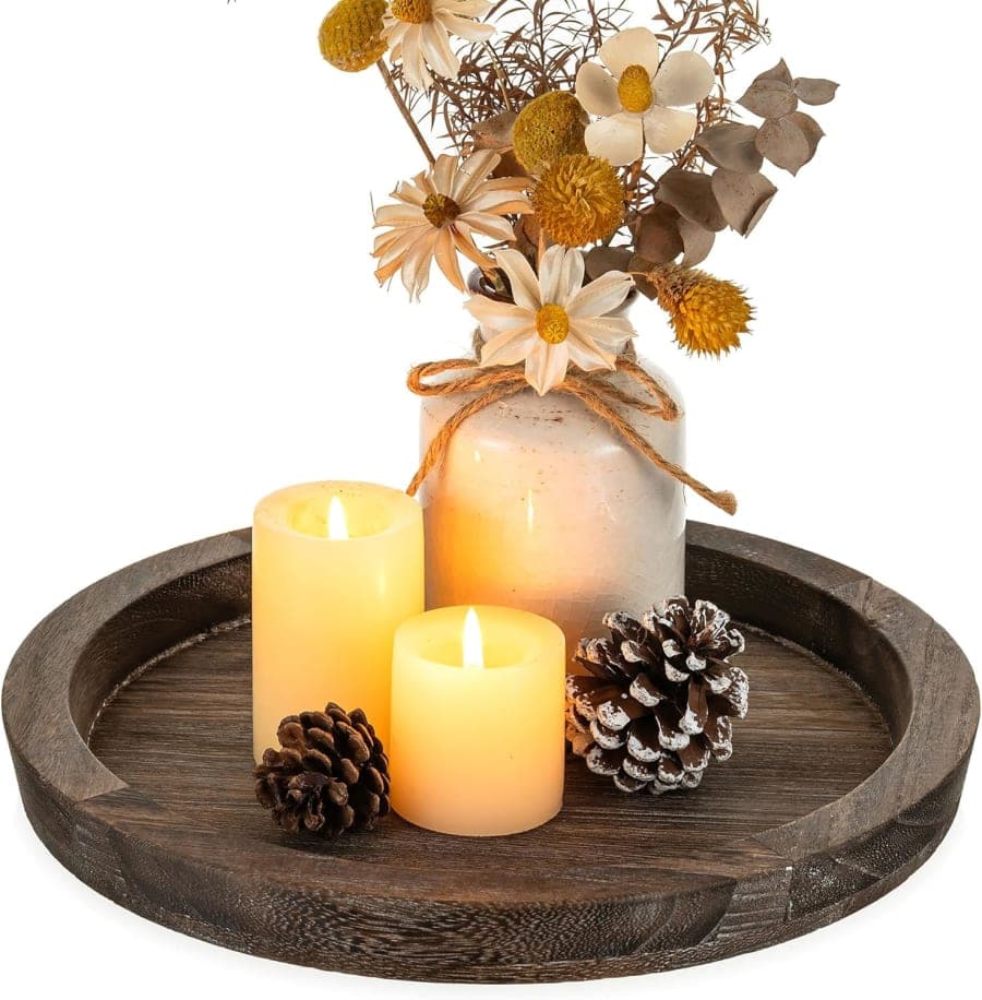 Dark round wooden tray with rustic farmhouse style for candles, flowers, and coffee table decor