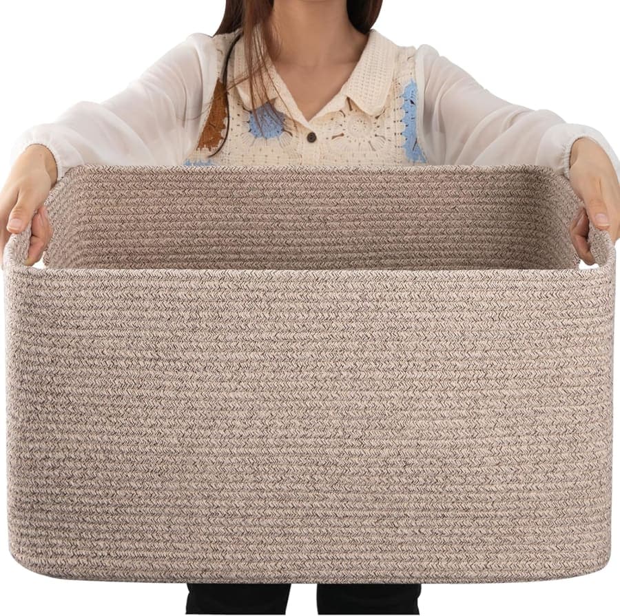 Large brown woven cotton rope storage basket with handles for blankets, toys, and living room organization
