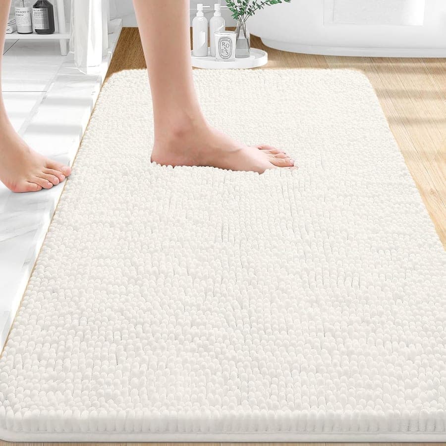 Ivory chenille bath rug with plush texture and rubber backing for soft bathroom floor comfort