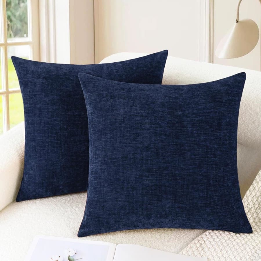 Navy blue chenille pillow covers styled on a cream sofa for cozy modern living room decor