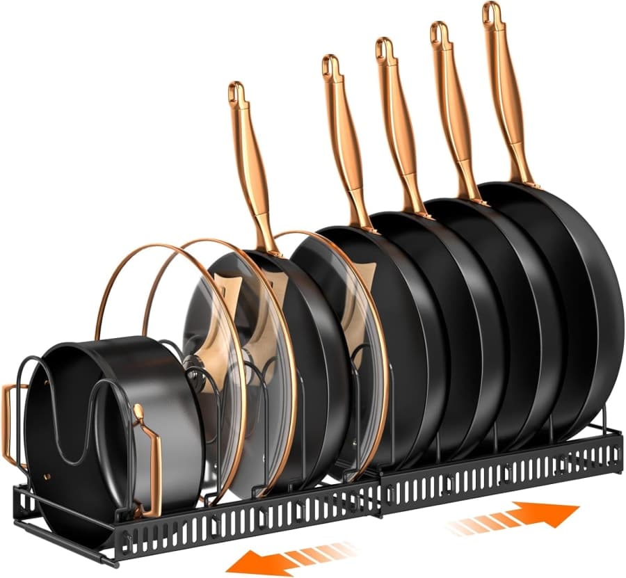 Expandable black cabinet rack holding pans, pot lids, bakeware, and cutting boards in adjustable compartments.