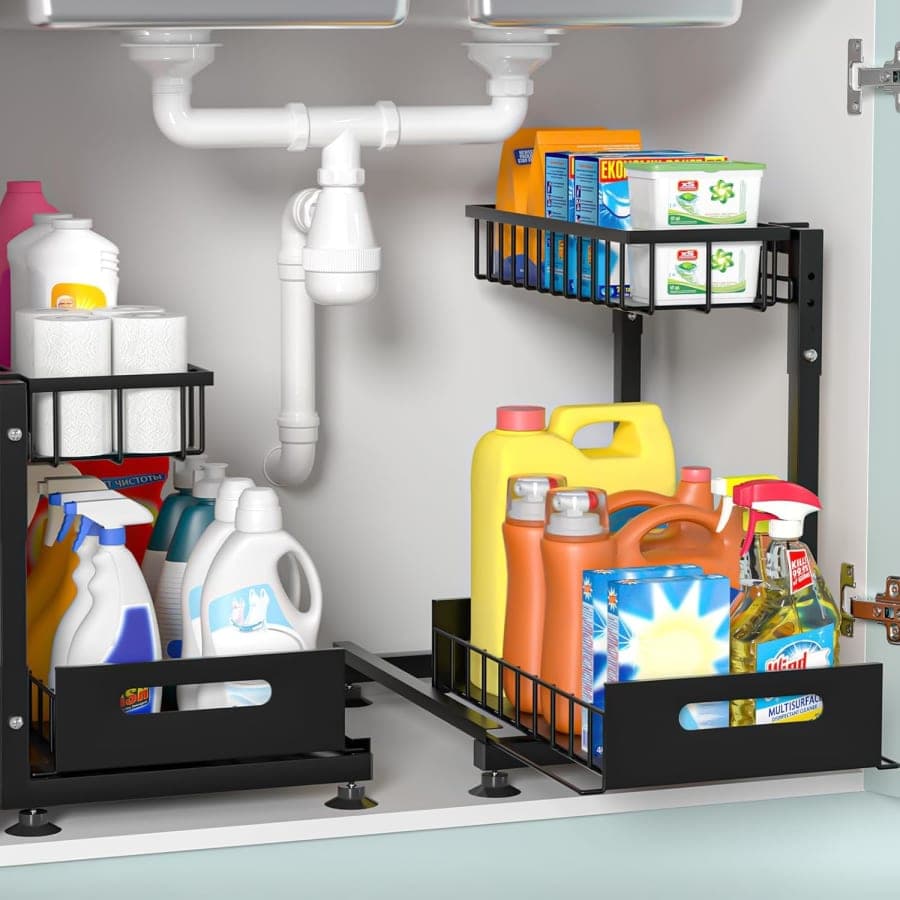 Black metal two-tier pull-out organizers storing cleaning supplies beneath a kitchen or bathroom sink.